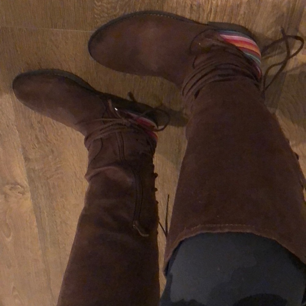 Dark brown boots with bright stripes and laces